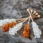 Rock Candy - five stones sticks on gray surface